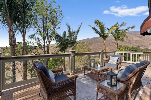 wooden terrace featuring outdoor lounge area and a mountain view