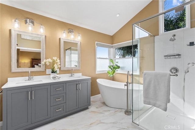 bathroom featuring vaulted ceiling, separate shower and tub, and vanity