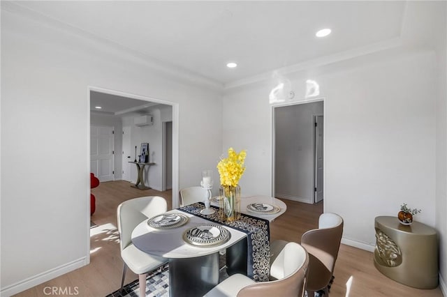 dining space with hardwood / wood-style flooring and a wall unit AC