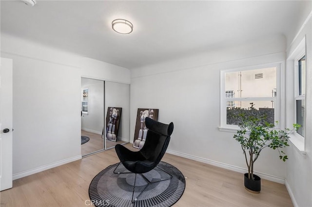 sitting room featuring light hardwood / wood-style floors