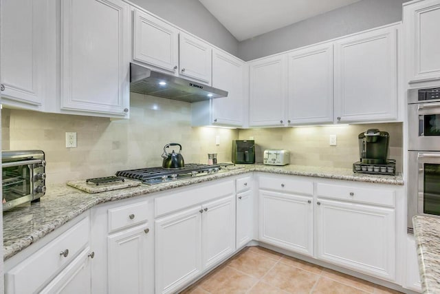 kitchen with white cabinetry and tasteful backsplash