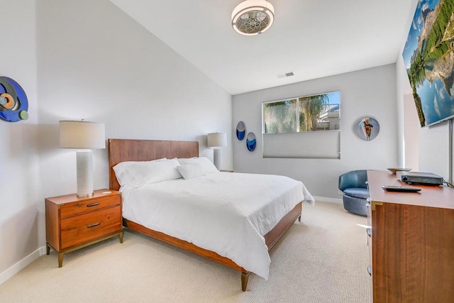 bedroom with light carpet and vaulted ceiling