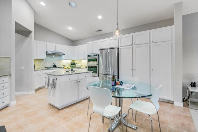 kitchen with light tile patterned floors, hanging light fixtures, light stone countertops, stainless steel appliances, and white cabinets