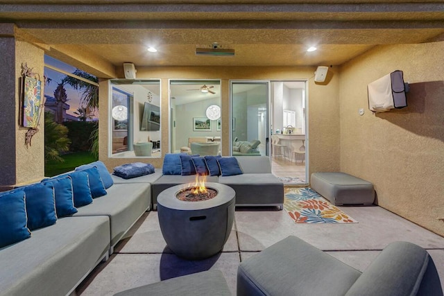 view of patio / terrace with an outdoor living space with a fire pit