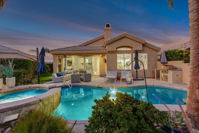 pool at dusk with an in ground hot tub, an outdoor hangout area, area for grilling, and a patio