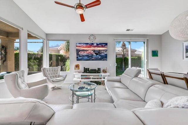 carpeted living room featuring ceiling fan