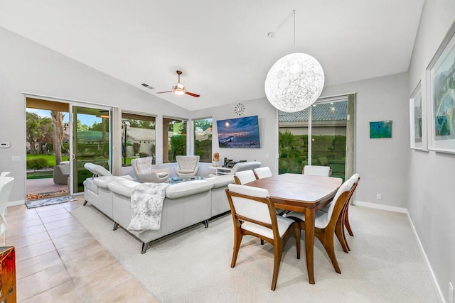 tiled dining space featuring ceiling fan and lofted ceiling