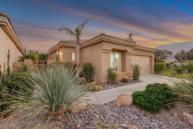 view of front of home with a garage and a mountain view