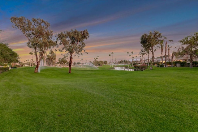 view of home's community featuring a water view and a lawn