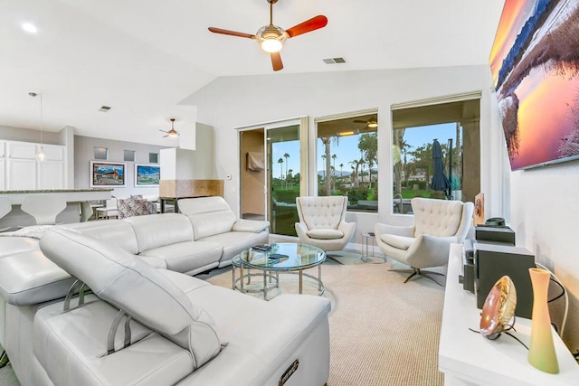 carpeted living room featuring ceiling fan and lofted ceiling