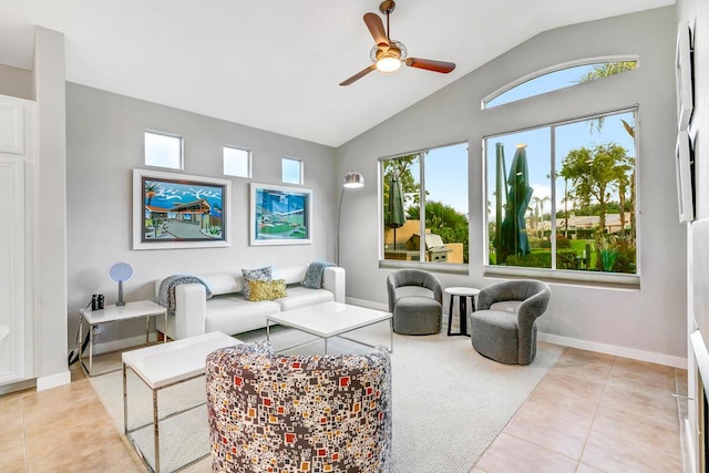 tiled living room with ceiling fan and high vaulted ceiling