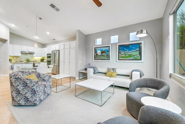 living room featuring vaulted ceiling and ceiling fan