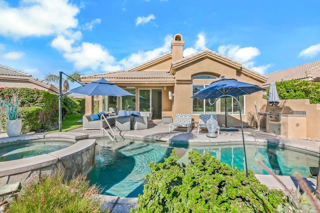 rear view of house featuring a swimming pool with hot tub, outdoor lounge area, exterior kitchen, and a patio