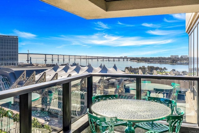 balcony featuring central AC and a water view