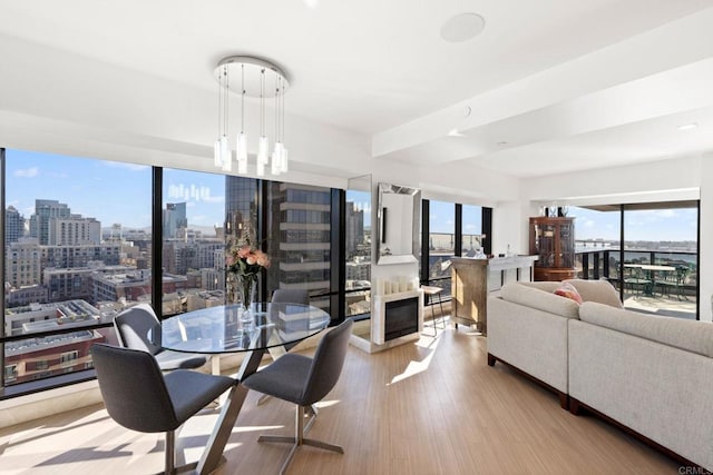 dining area with light wood-style floors and a view of city