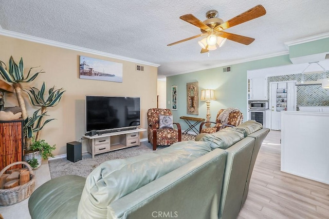 living room featuring ceiling fan, wine cooler, a textured ceiling, ornamental molding, and light hardwood / wood-style flooring