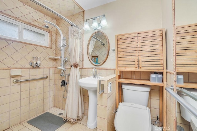 bathroom with toilet, tile patterned floors, tile walls, and a shower with curtain