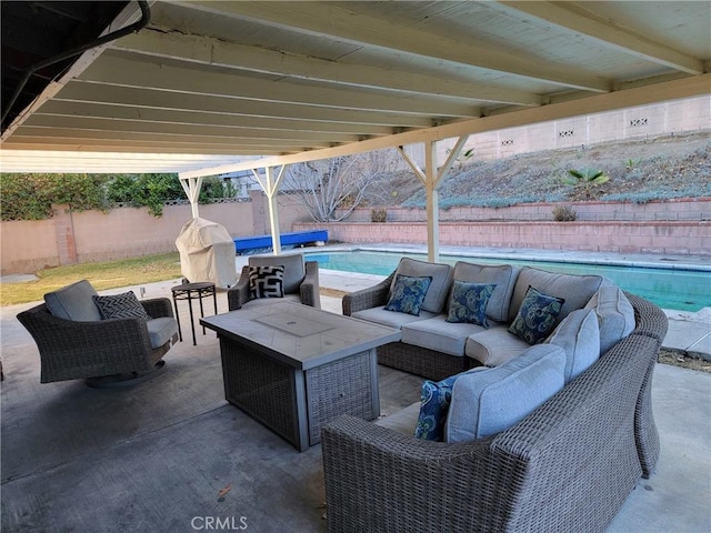 view of patio / terrace featuring an outdoor hangout area and a fenced in pool