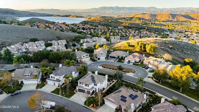 drone / aerial view featuring a water and mountain view