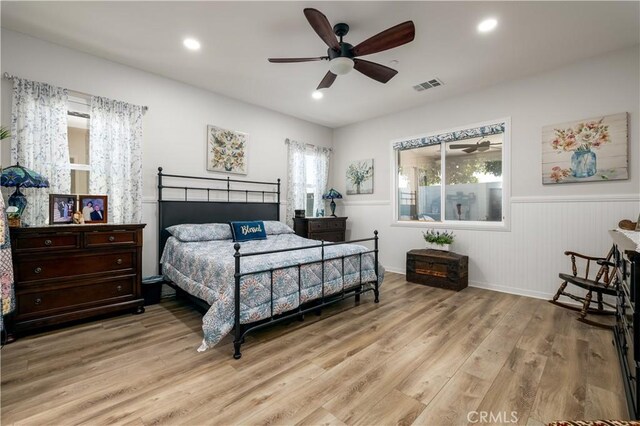 bedroom with ceiling fan and light wood-type flooring