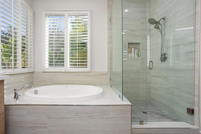 bathroom featuring separate shower and tub