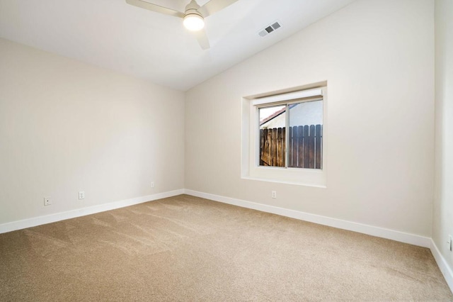 empty room featuring ceiling fan, carpet floors, and lofted ceiling