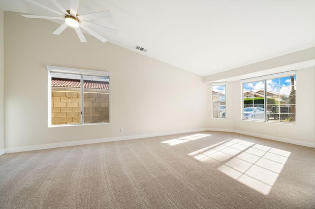 carpeted empty room with ceiling fan and lofted ceiling