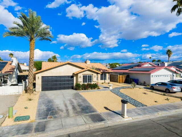 single story home featuring a garage and solar panels