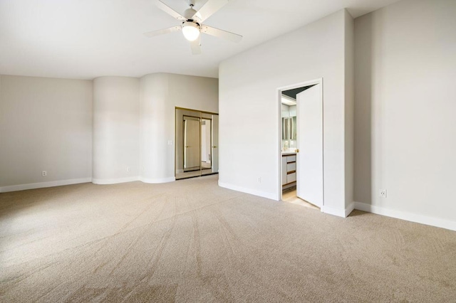 spare room featuring ceiling fan and light colored carpet