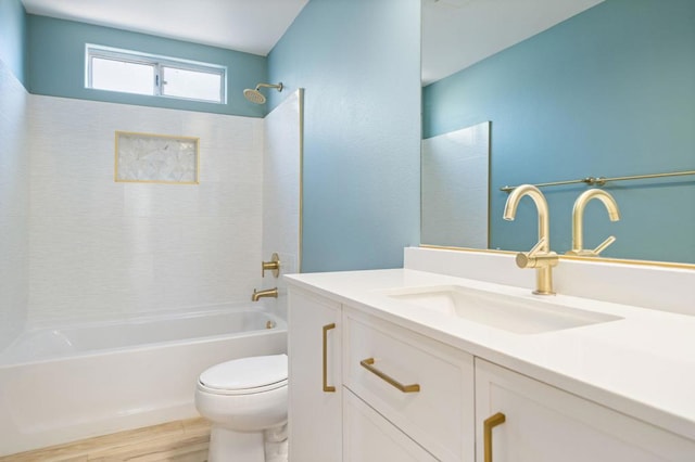 full bathroom featuring toilet, bathing tub / shower combination, hardwood / wood-style flooring, and vanity