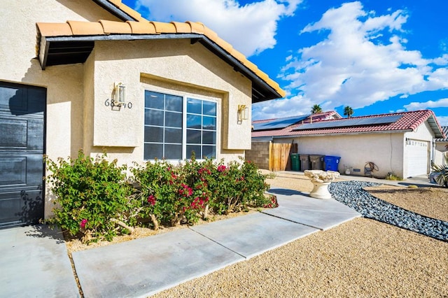 exterior space with solar panels and a garage