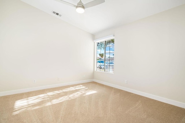 carpeted empty room with ceiling fan and vaulted ceiling