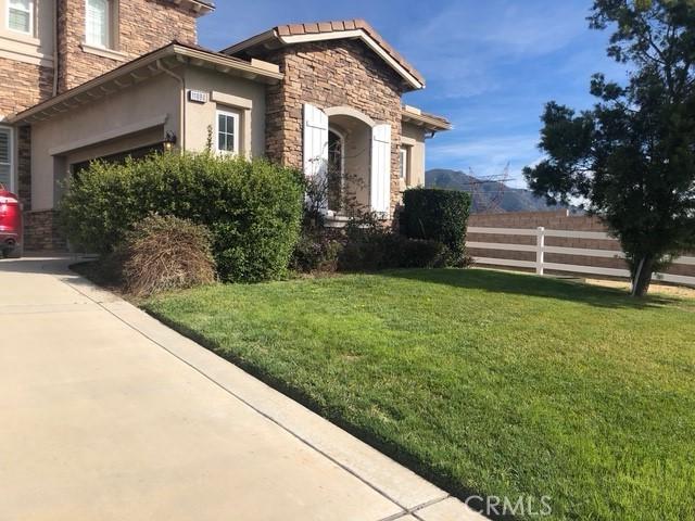 11090 Hiddentrail Dr, Rancho Cucamonga, CA 91737 - view of home's exterior with a yard