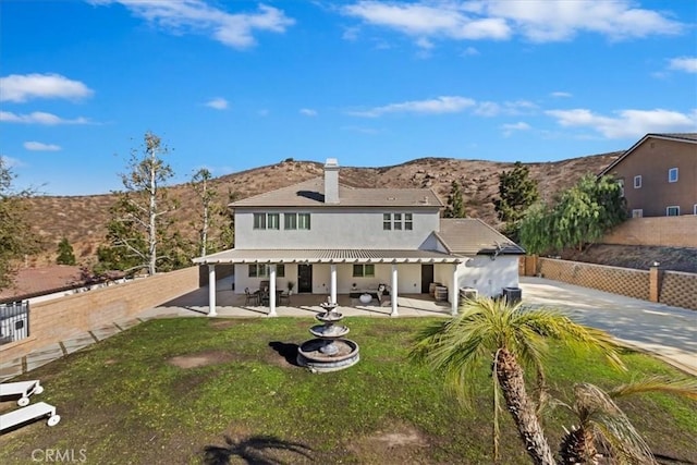 rear view of property featuring a patio and a mountain view