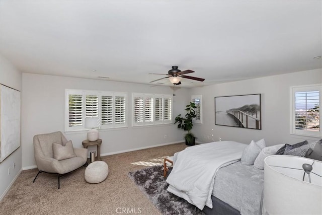 carpeted bedroom with multiple windows and ceiling fan