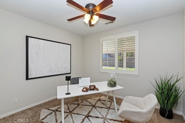 carpeted home office featuring ceiling fan