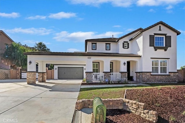 view of front of property with covered porch and a garage