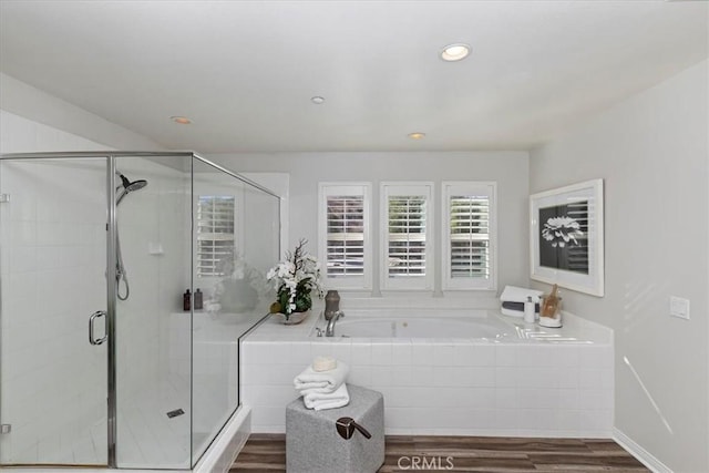 bathroom featuring separate shower and tub and hardwood / wood-style flooring