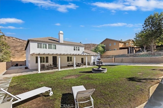 rear view of house with a patio area and a yard