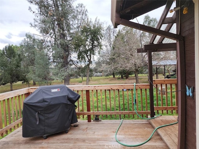 deck featuring a grill and a yard