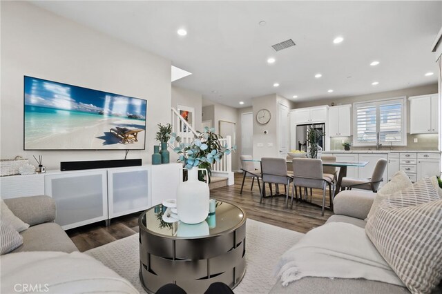 living room with wood-type flooring and sink