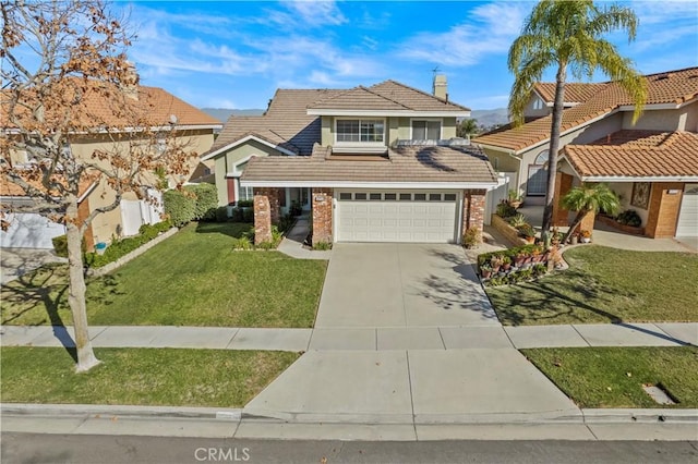 view of property featuring a front lawn and a garage