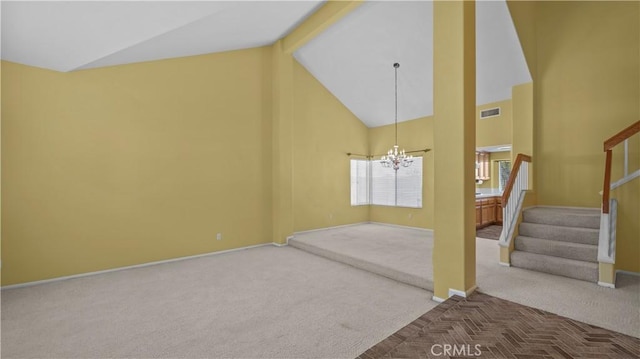 unfurnished living room featuring an inviting chandelier, carpet flooring, and high vaulted ceiling