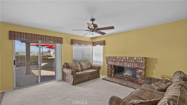 living room with ceiling fan, light colored carpet, and a fireplace