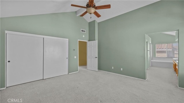 unfurnished bedroom featuring ceiling fan, light colored carpet, a closet, and high vaulted ceiling