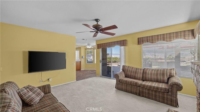 carpeted living room featuring ceiling fan