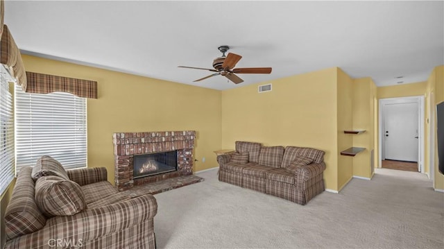 carpeted living room featuring ceiling fan and a fireplace