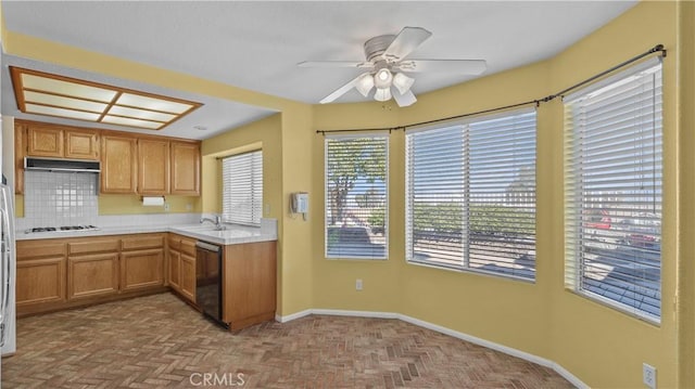 kitchen with ceiling fan, tasteful backsplash, dishwasher, white gas cooktop, and sink