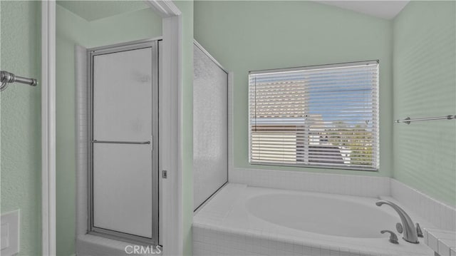 bathroom with shower with separate bathtub