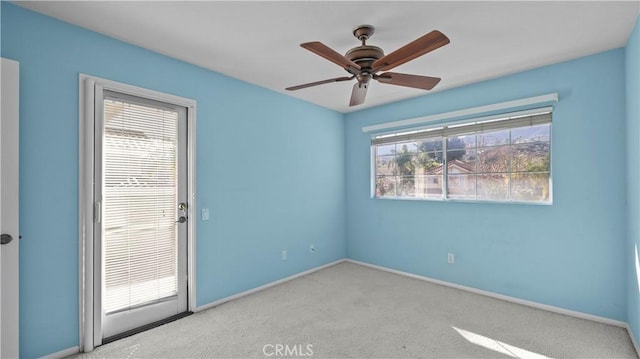 empty room with light carpet, a healthy amount of sunlight, and ceiling fan